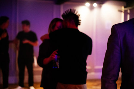 A group of young people dancing at a party in a nightclub.の写真素材