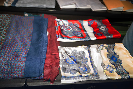 Close up view of a collection of colorful fabrics in a shop window.の写真素材