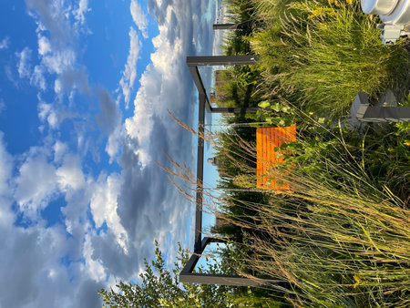 Modern apartment building exterior with blue sky and white clouds. Panoramic view.の写真素材