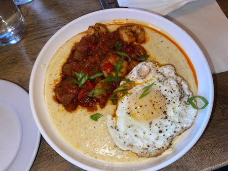 Traditional breakfast with egg and tomato sauce on a plateの写真素材