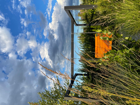 Orange shutters on the background of blue sky with cloudsの写真素材