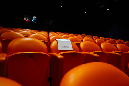 Empty orange chairs in cinema hall, cinema hall or auditorium for audience.の写真素材