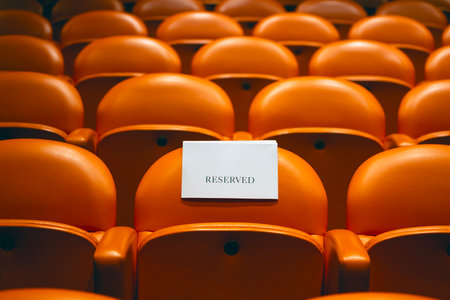 Empty seats in the auditorium of the theater with a cardの写真素材