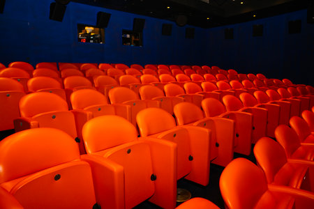 Orange chairs in the cinema auditorium, waiting for the audience.の写真素材