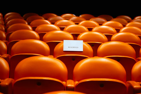 Empty seats in the auditorium of the stadium with a blank cardの写真素材