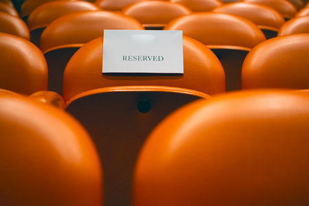Empty chairs in an empty auditorium with a white card.の写真素材