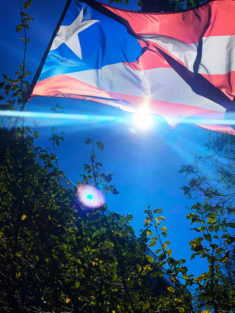 Puerto Rico flag waving in the sun against the blue skyの写真素材