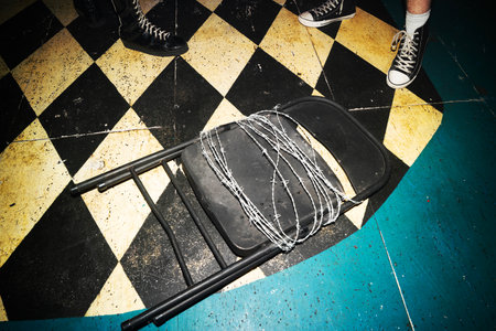 Close up of a folding chair with wire attached to itの写真素材