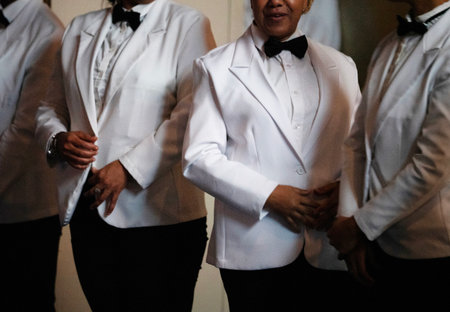 Waiter wearing a tuxedo and bow tie during a wedding partyの写真素材