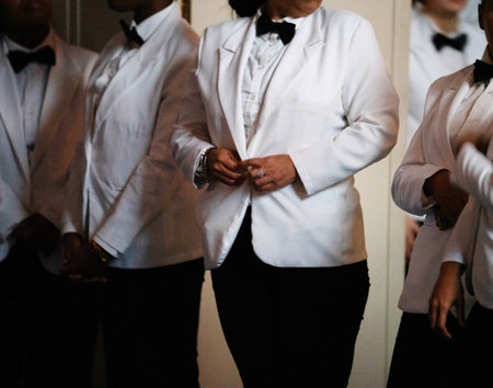 Waiter in white shirt and bow tie preparing for wedding ceremony.の写真素材
