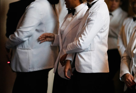 Close-up of male and female waiters in white uniform.の写真素材