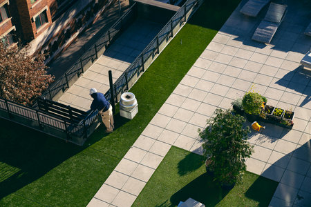 Aerial view of a man cleaning the gardenの写真素材