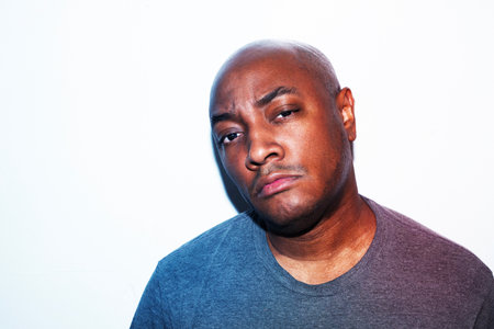 Portrait of a young african american man against white backgroundの写真素材