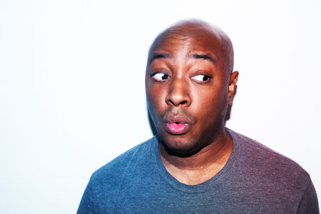 young african american man making funny face isolated on white backgroundの写真素材