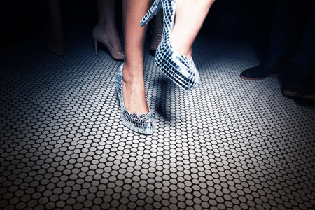 Close up of female legs in high-heeled shoes on the floorの写真素材