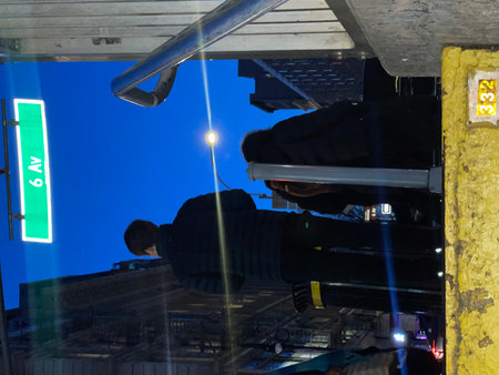A man climbs the stairs to the top of the building in the evening.