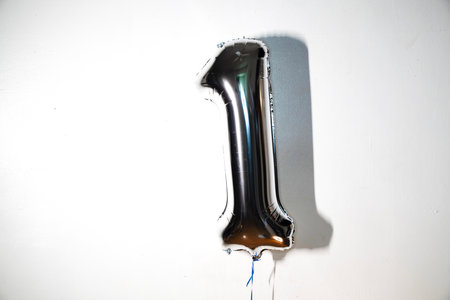 Number 1 silver balloon on white background. Birthday or anniversary celebration.の写真素材