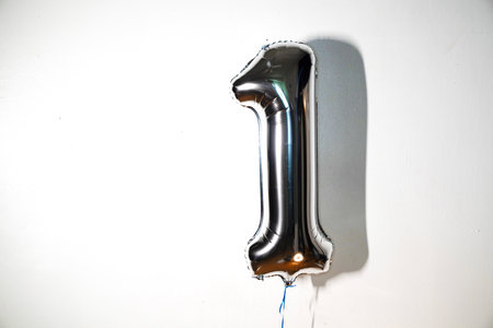 Silver balloon number 1 on a white background. Birthday greeting card.の写真素材