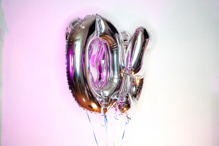 Silver balloon on a pink background.の写真素材