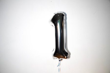 Number 1 silver balloon on a white background. Birthday or anniversary celebration.の写真素材