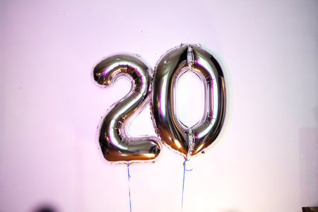 20th birthday celebration. Foil balloon with number 20 on white backgroundの写真素材