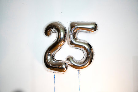 Number 25 silver balloon on white background. Birthday celebration. Anniversary concept.の写真素材