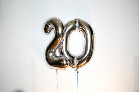 Number 20 gold foil balloon on white background. Birthday party decoration.の写真素材