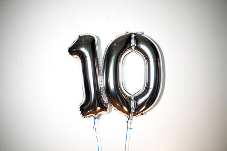 Number 10 silver foil balloon on a white background. Birthday or anniversary celebration.の写真素材
