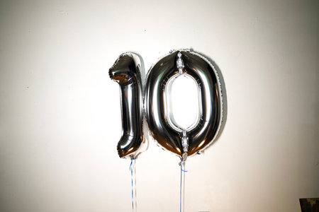 Number 10 silver foil balloon on white background. Birthday or anniversary celebration decoration.の写真素材
