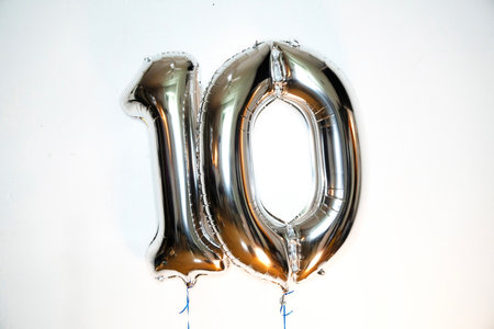 Number 10 gold foil balloon on a white background. Birthday party decorationの写真素材