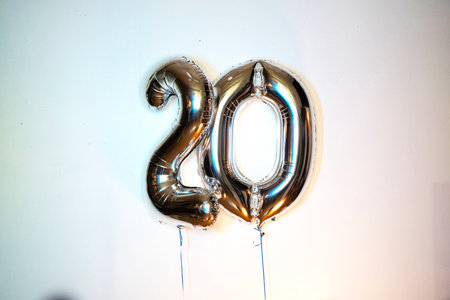 20th birthday celebration gold foil balloon in the shape of number 20の写真素材