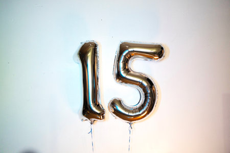 Number 15 gold foil balloon on white background. Number 15 silver balloonの写真素材