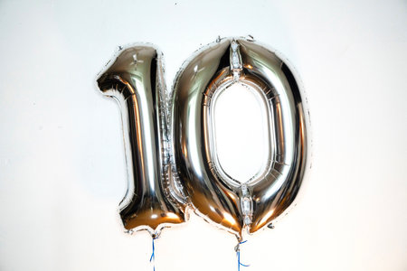 Number 10 gold foil balloon on white background. Birthday or anniversary decorationの写真素材