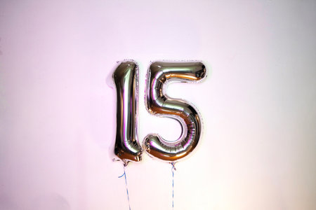Number 15 gold foil balloon on a white background. Birthday, anniversary, party celebration.の写真素材