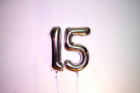 Number 15 silver balloon on white background. Birthday or anniversary celebration.の写真素材