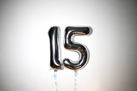 Number 15 silver balloon on a white background. Birthday party decoration.の写真素材