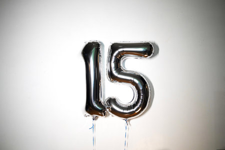 Number 15 silver foil balloon on white background. Birthday party decoration.の写真素材