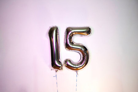 Number 15 gold foil balloon on a white background. Birthday party.の写真素材