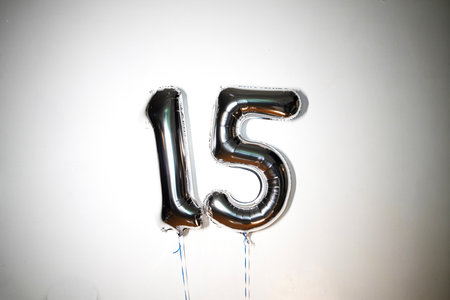 Number 15 silver foil balloon on white background. Birthday party decoration.の写真素材