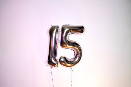 Number 15 gold foil balloon on a white background. Birthday celebration.の写真素材