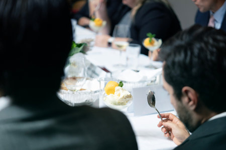 selective focus of businesspeople eating dessert at table in conference hall