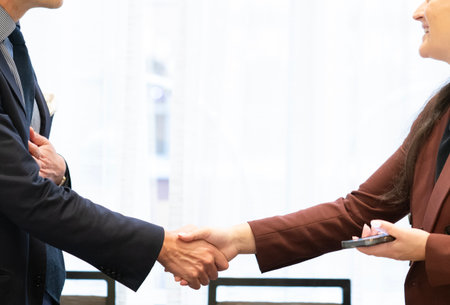 Business people shaking hands, finishing up a meeting in the office.の写真素材