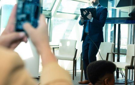 selective focus of photographer taking picture of african american colleagueの写真素材