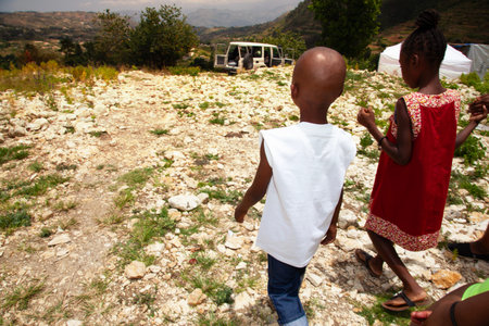 Rear view of african american boy and girl holding handsの写真素材