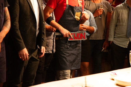 Close up of waiter serving food to customers in a restaurant.の写真素材