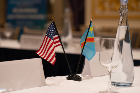 Table set for an event party or wedding reception with flags of the USA and the Congoの写真素材