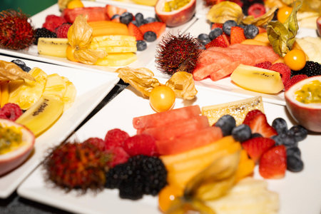 Catering buffet with variety of fruits and berries. Food styling and restaurant meal serving