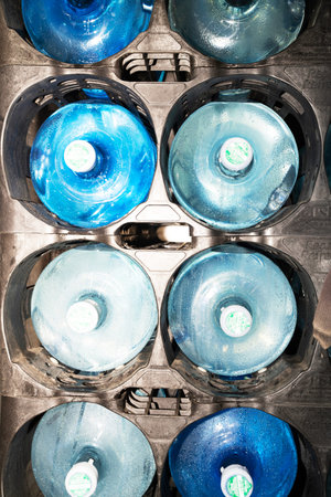 Top view of a group of blue plastic bottles in a recycling bin