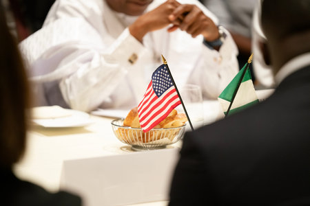 Close-up of african american people sitting at table and eating with usa flag