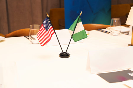 Flags of the United States and Nigeria on a table in a restaurantの写真素材